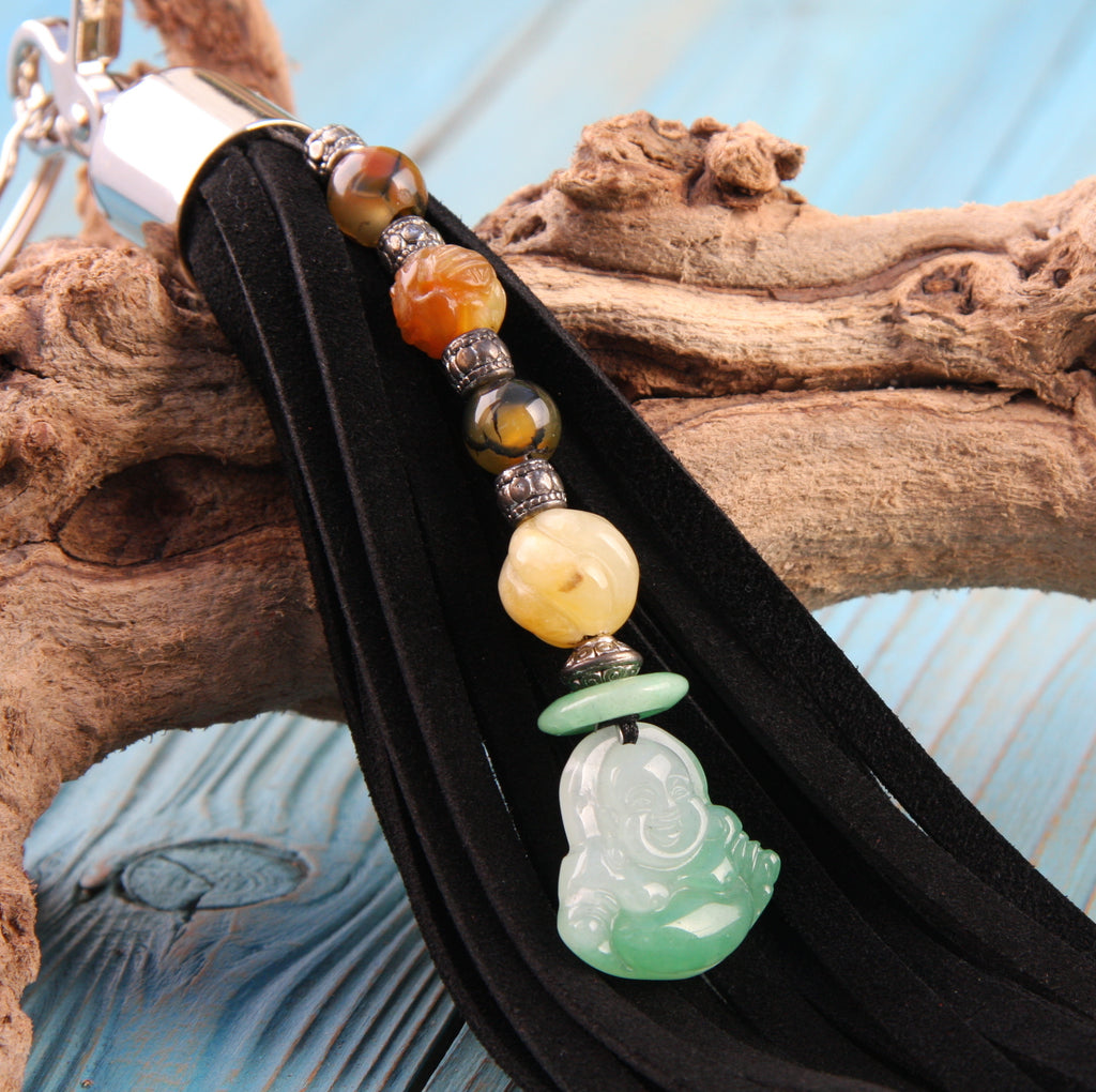 9 inch black suede beaded tassel with aventurine buddha jade and carnelian on blue background close up view
