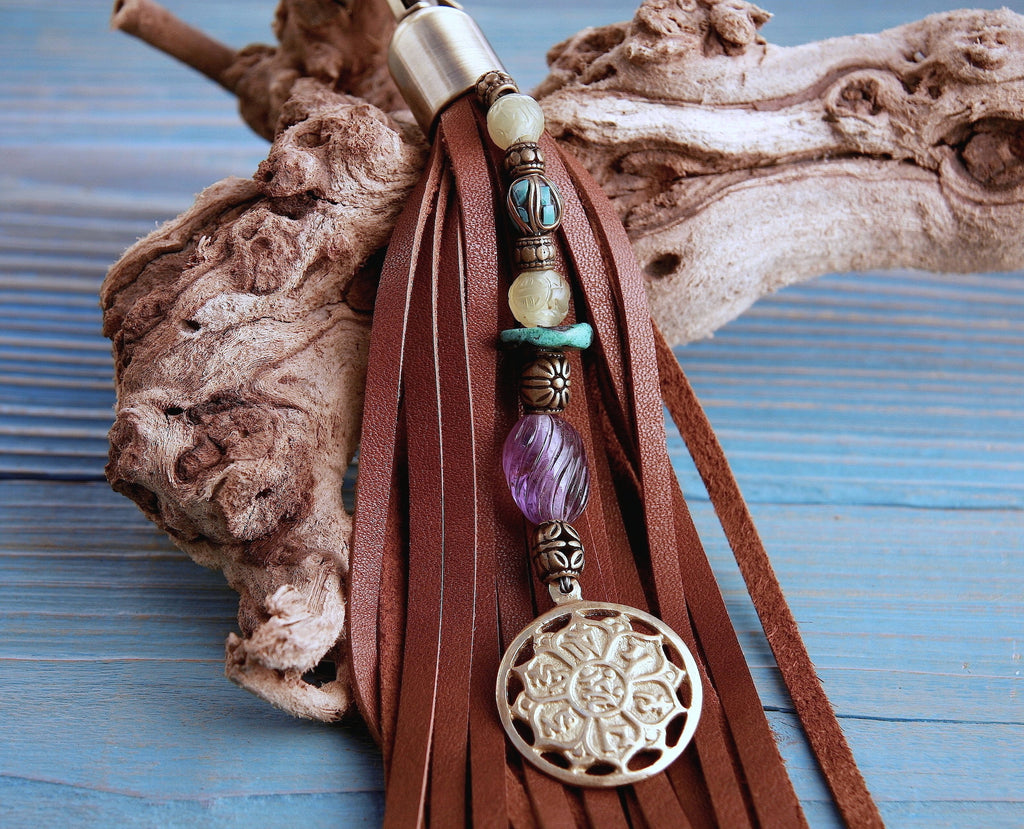 brown leather tassel key chain purse charm beaded with semi precious stones and brass tibetan lotus prayer wheel pendant close up