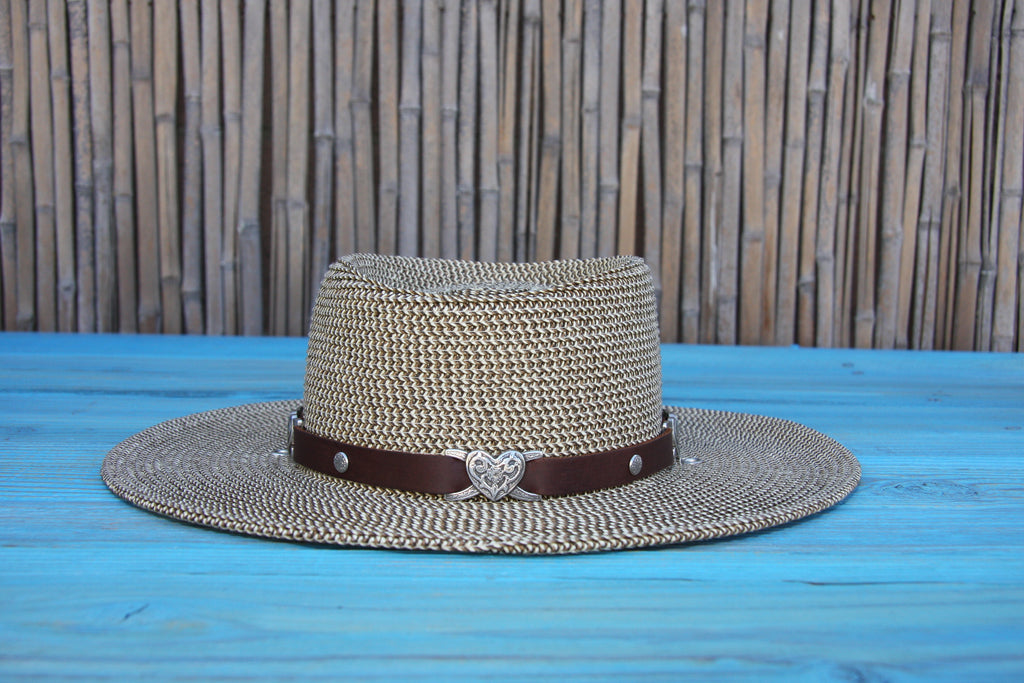 brown leather hatband with embossed nickel heart slider conchos three quarter inch thick on a straw hat with bamboo background
