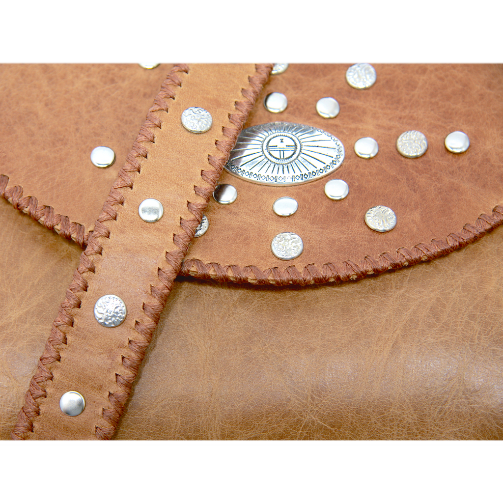 Tan envelope bag with studded flap and shoulder strap detail close up