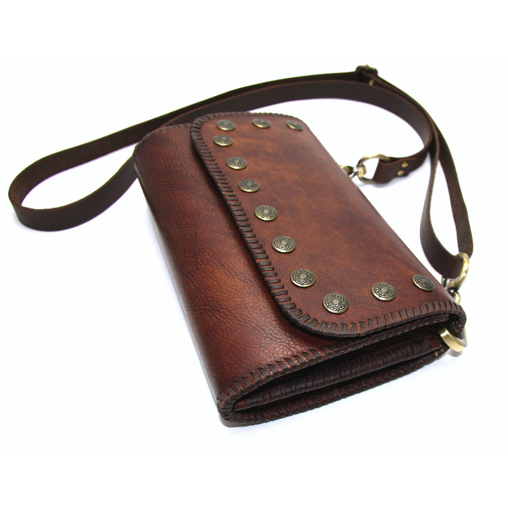 handmade brown leather cross body with hand stitched detail and decorative brass studs side view
