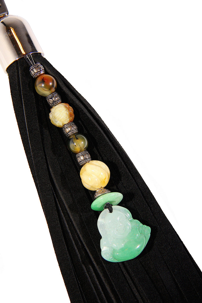 buddha pendant with jade and carnelian beads attached to 9 inch long black suede tassel key fob purse charm close up view