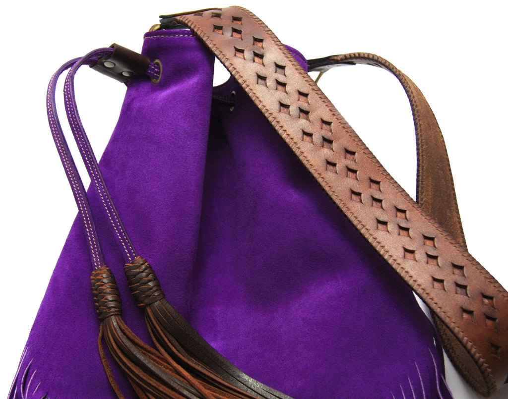 close up of shoulder strap made from brown vintage belt on purple fringe suede handbag