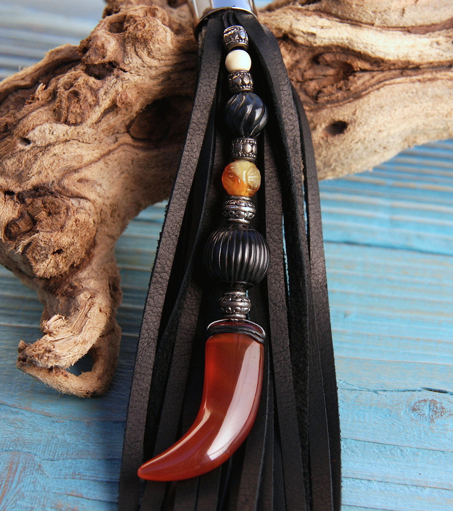 beaded leather tassel key fob purse charm with carnelian claw bead fossilized coal and floral carved carnelian beads
