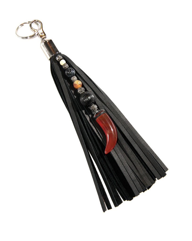 9 inch black leather fringe key fob beaded with carnelian claw pendant Black tiger eye jade and fossilized coal in front of white background