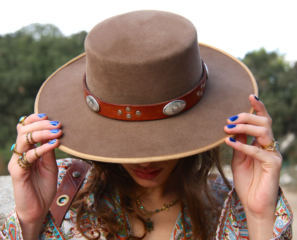 woman wearing tan bolero hat with brown bohemian eagle concho hatband 